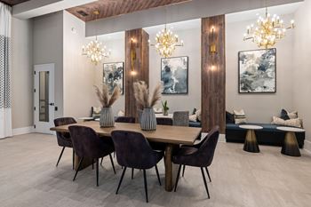 A dining room with a wooden table and chairs.
